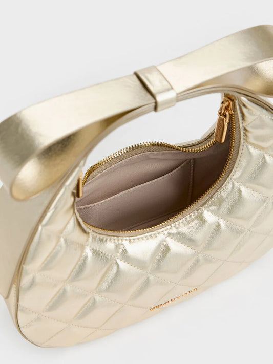 PREORDER Charles and Keith Janie Metallic Quilted Bow-Handle Crescent Bag - Champagne